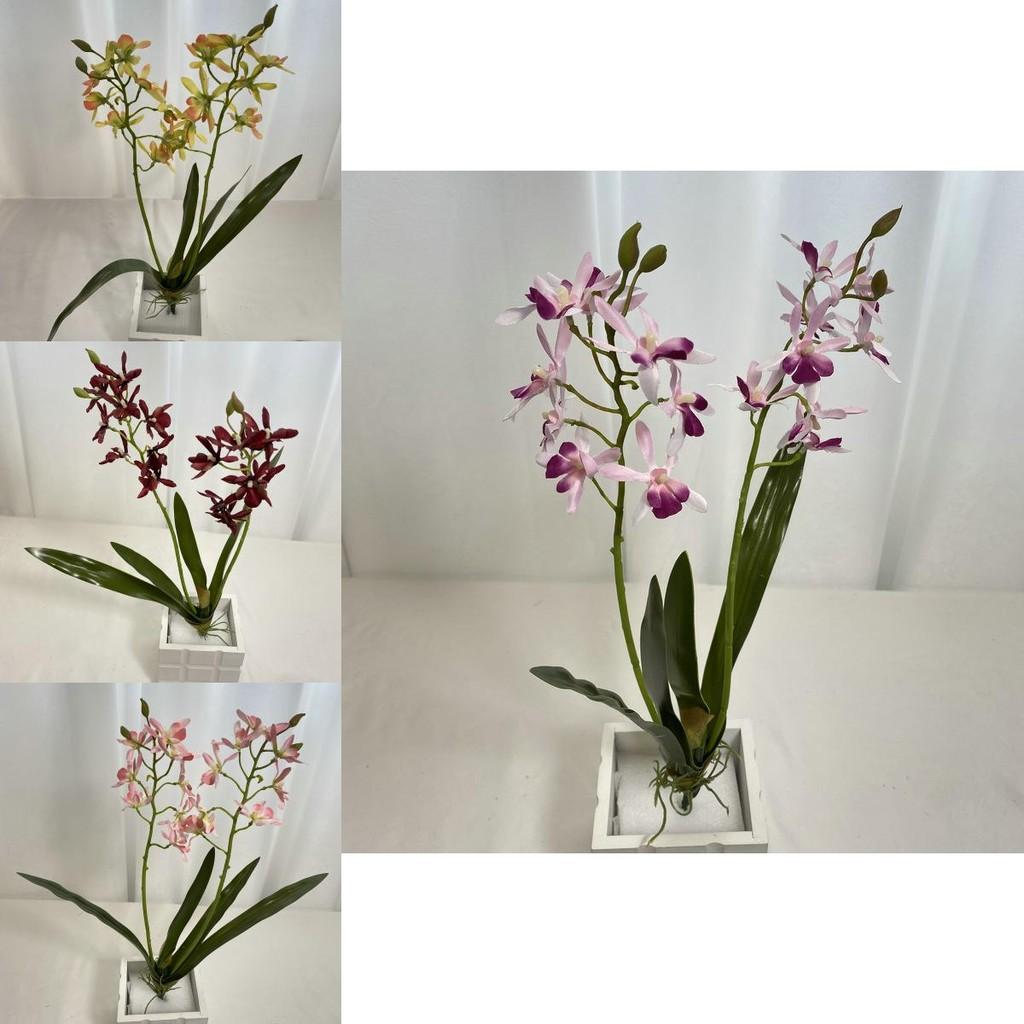 Realistische Seiden-Dendrobium-Orchidee mit Blättern für Blumengesteck auf dem Esstisch
