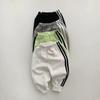 Korean-Style Unisex Baby Sweatshirt and Pants Set - Solid Color with Webbing Stripe Patchwork for Autumn and Spring.