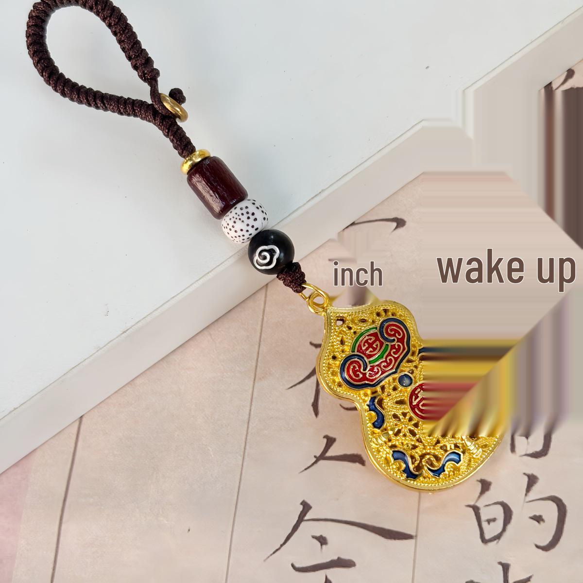 

Китайский брелок из песочного золота с молитвенным барабаном мира и подвеской в виде полой тыквы-горлянки