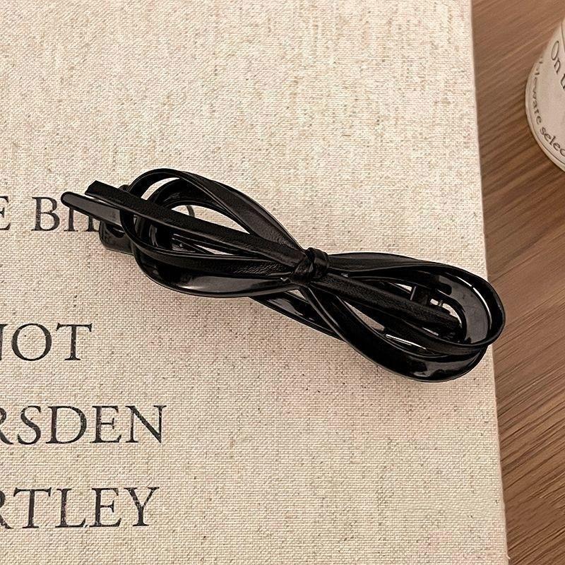 

A fashionable and sweet leopard print updo headpiece with a leather bow twist clip on the back of a woman s head Size fits all