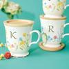 This Elegant 350ml Mug Features a Delicate Floral Design and a Gold Initial It Comes with a Coaster That Doubles As a Lid or Small It Also Comes In a