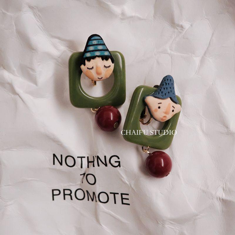 

Studio Vintage Fun Childlike Doll Earrings with Beads A pair of silver stud earrings