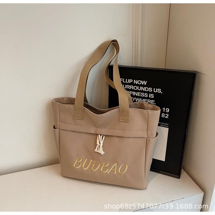 

Large capacity canvas bag women 2025 new fashion letter shoulder canvas bag college students class commuting tote bag