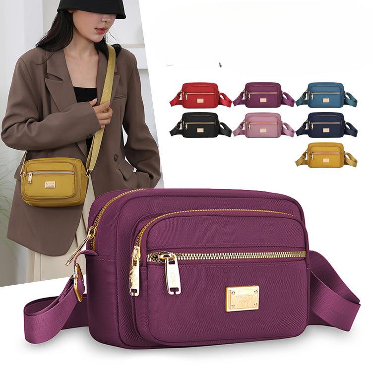 New Portable Oxford Cloth Mother Bag Fashion Simple Multi Layer Middle Aged Shoulder Bag Atmosphere Joker Slung Small Bag.