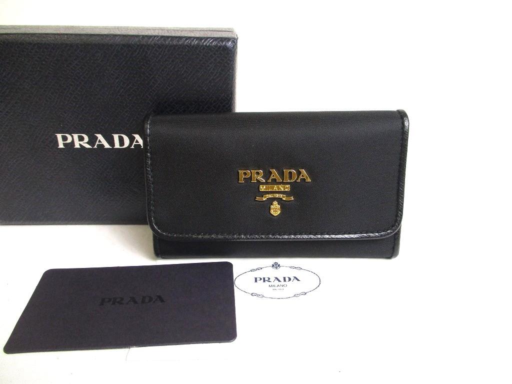 

Автентичний брелок для ключів PRADA з чорного нейлону та шкіри, золота H/W, 6 зображень №a289, відремонтований