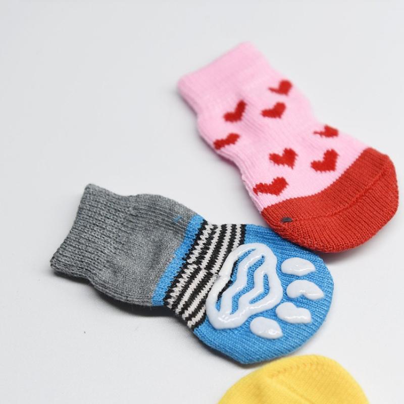 Four-pack of autumn/winter cartoon anti-slip socks for pets, including cat and dog warm socks with paw prints, perfect as a holiday gift.