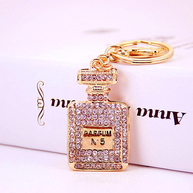 Elegant Diamond-Studded Four-Leaf Clover Keychain: Perfume Bottle Bag Charm for Women