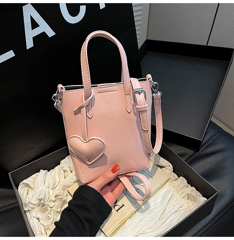 

Versatile fashion portable high-end commuter tote bag women s new silver peach heart shoulder bag oblique span bag рожевий