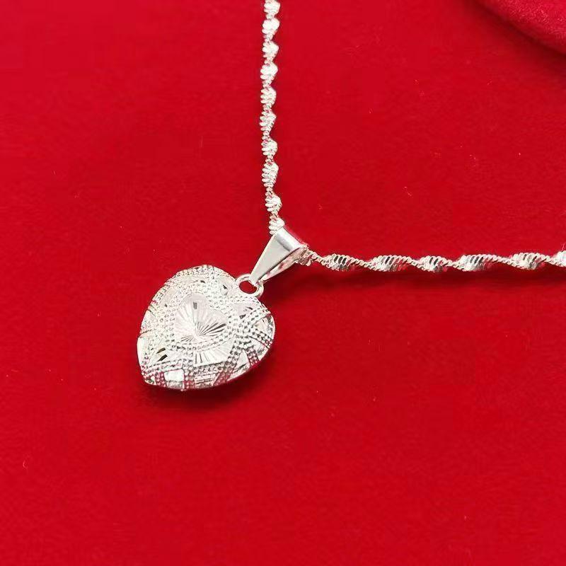 Silver Alloy Hollow Heart Pendant Necklace with Water Wave Chain for Women