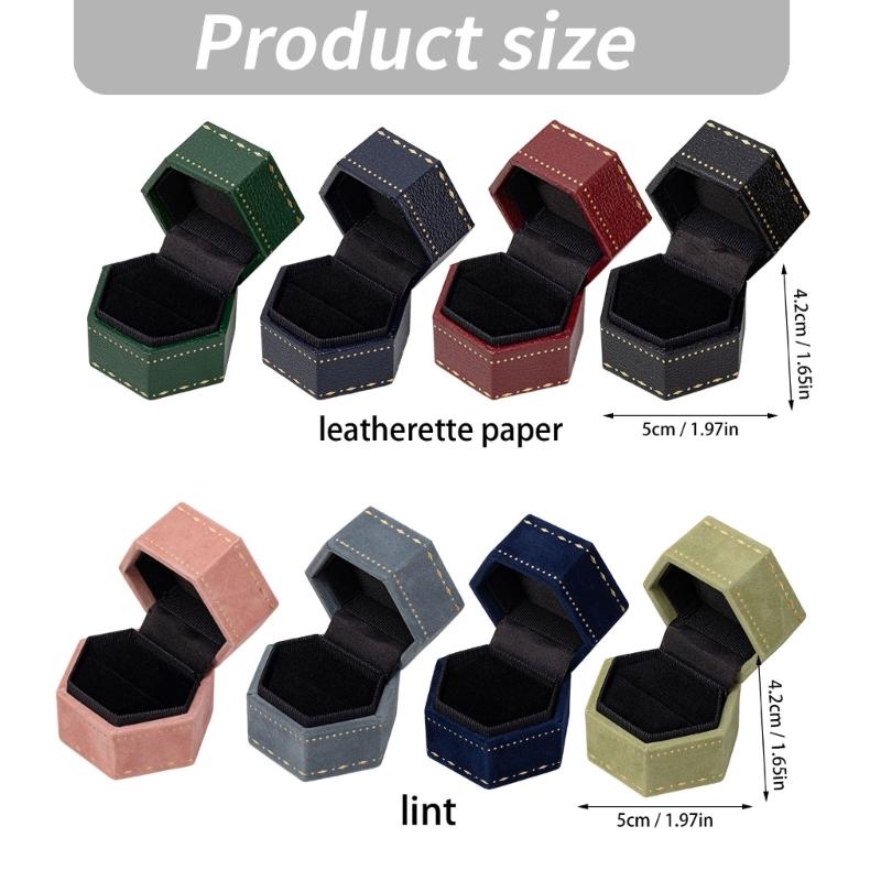 Hexagonal Ring Presentation Box with Black Interior, Gold-Tone Border Pattern, and Attached Lid for Retail Display