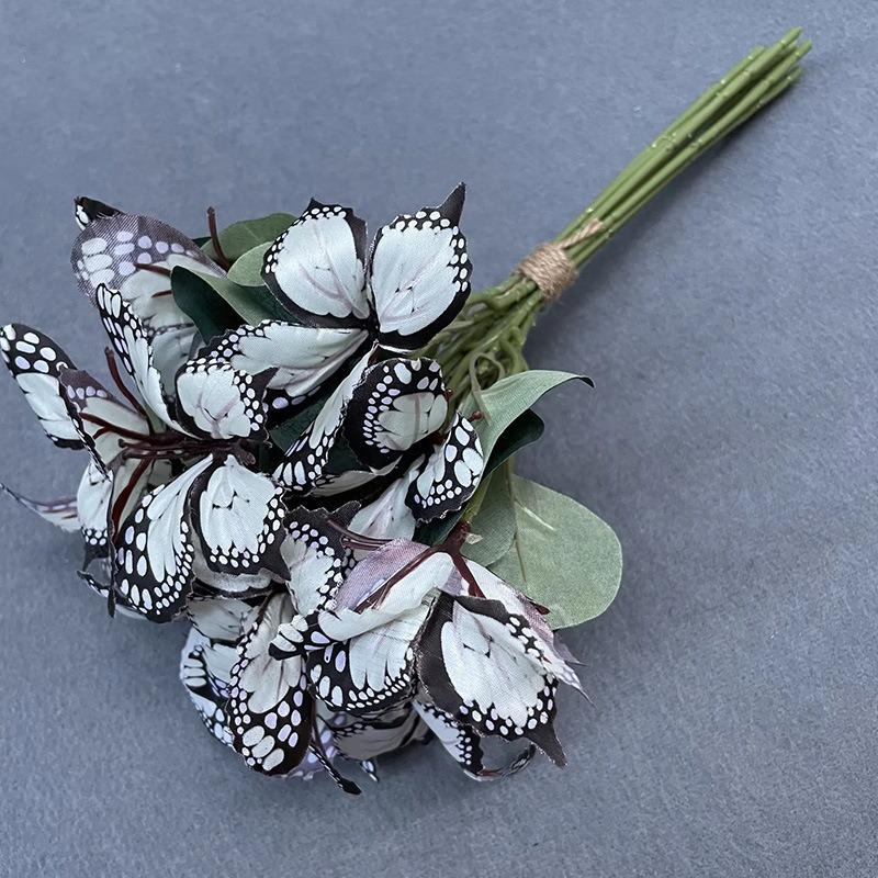 

Свадебная невеста держит цветы Фотосъемочная группа Задний план Композиция Держа 9 маленьких бабочек Шелковые цветы