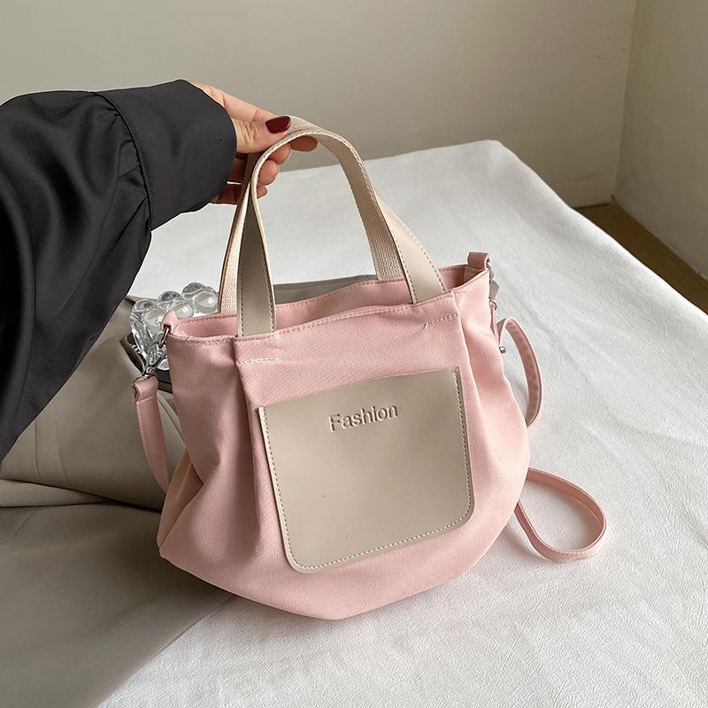 

Commuter bag women s 2024 new large-capacity handheld schoolbag beautiful personality leisure student shoulder messenger women s bag рожевий