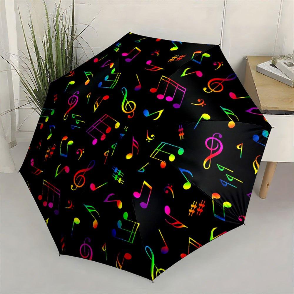 Faltbarer Regenschirm, buntes Notenmuster, schwarzer Hintergrund. Kreativer tragbarer Faltregenschirm Weihnachten und andere Feiertage