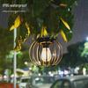 Solar Wrought Iron Lantern Light: Retro Mesh Pendant for Outdoor Garden, Courtyard, and Balcony Ambiance.