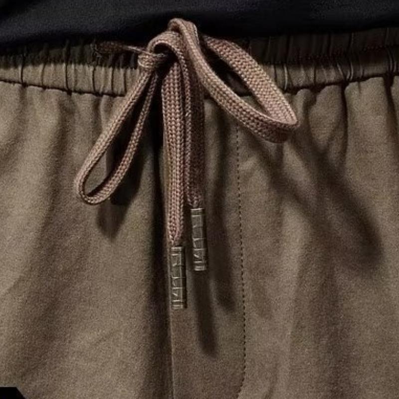 Męskie spodnie cargo z elastycznym pasem i wieloma wiązaniami, luźne, z wieloma kieszeniami i prostymi nogawkami, modne spodnie ogrodniczki