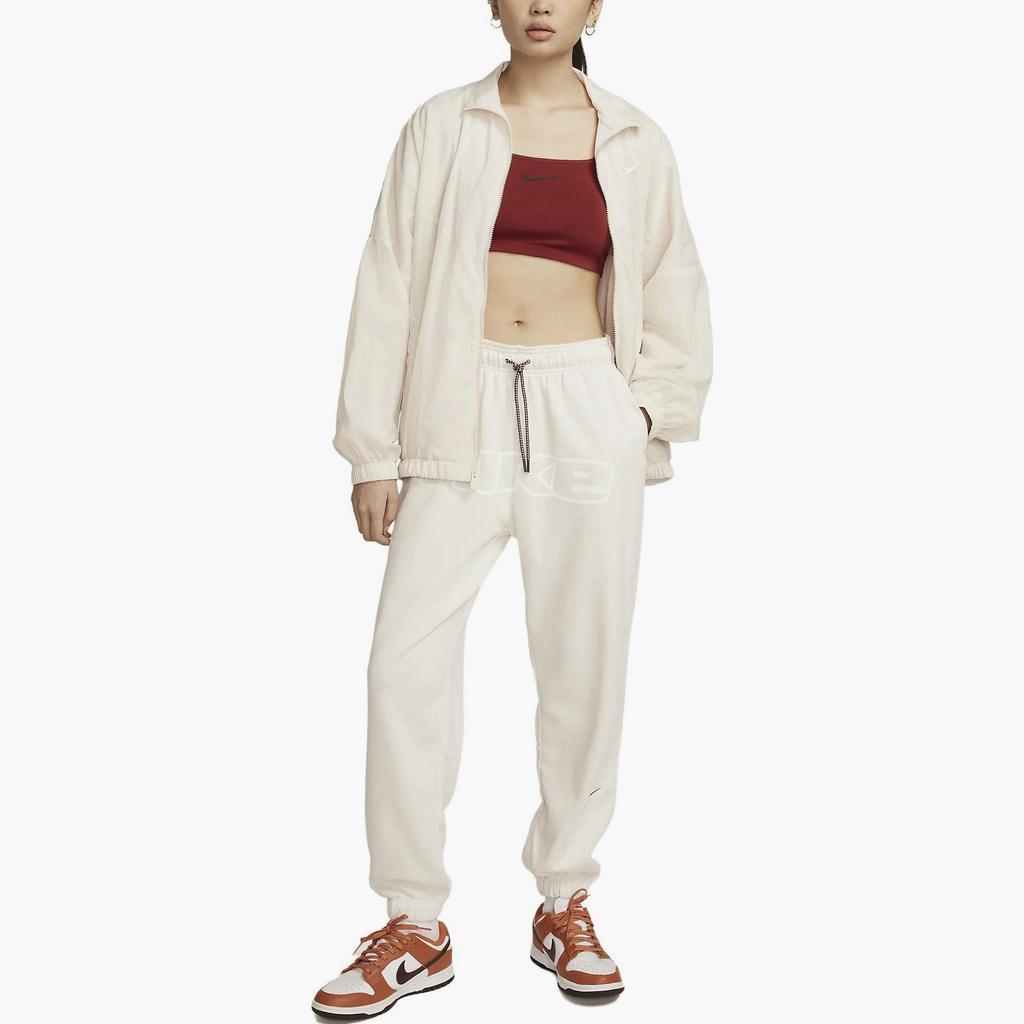 Nike Spodnie casualowe z mankietami i elastyczną talią z nadrukiem literowym Damskie doły Beżowy FQ0367-030