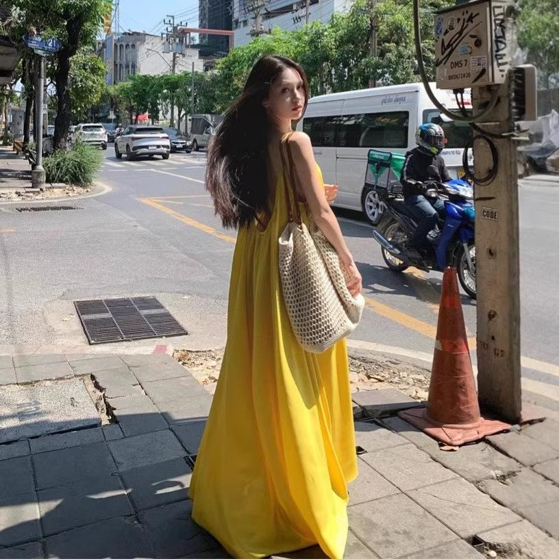 Seaside vacation sexy backless suspender dress women's summer new loose a-word skirt gentle yellow long skirt