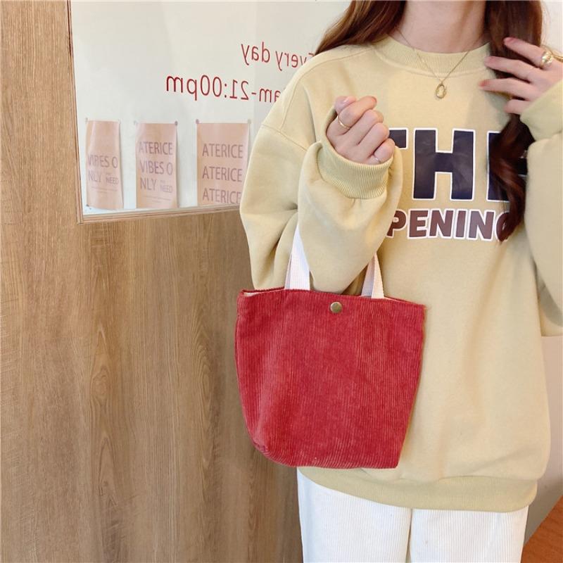 [Spot] Literary and artistic corduroy bag portable casual women's small hand bag retro cloth bag bento bag