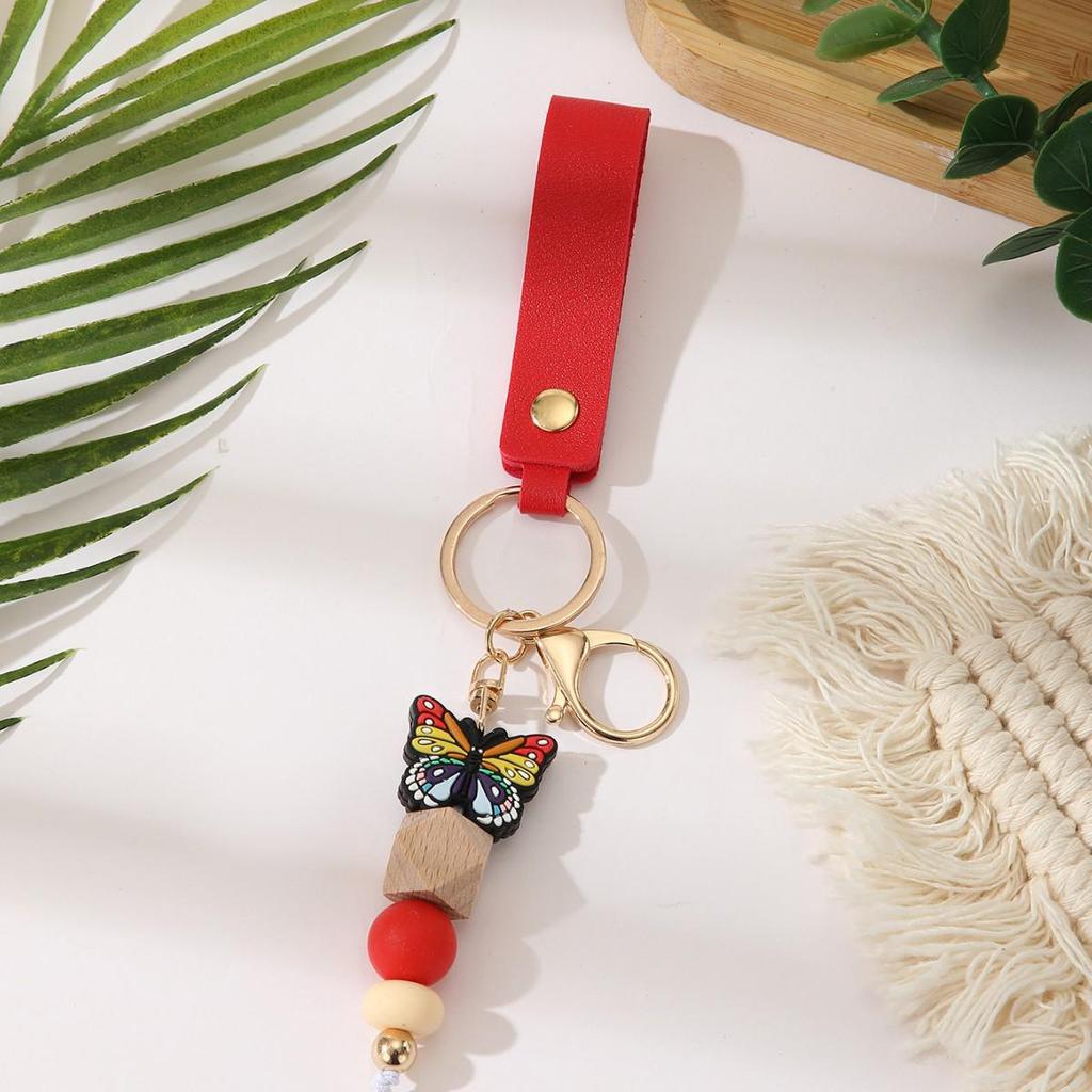 European & American Sweet Butterfly Daisy Silicone Beaded Keychain with Leather Bow Pendant