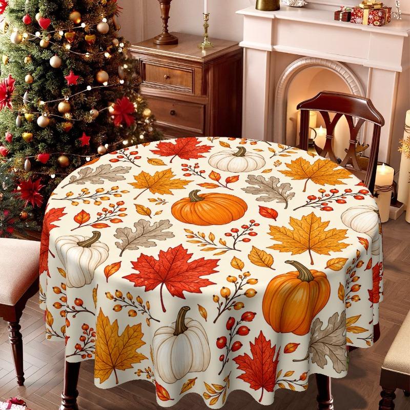 Un mantel, con un estilo temático, que presenta un estampado de calabazas y hojas inspirado en el otoño en la superficie.zyc