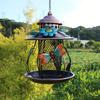 An outdoor hanging bird feeder with hooks and iron mesh, featuring decorative dragonfly and flower patterns, suitable for use in gardens or