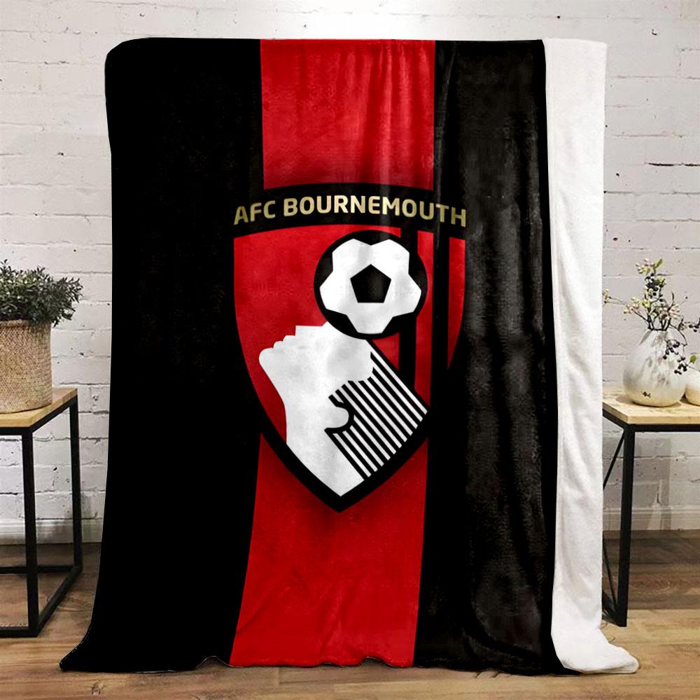 A shield with a soccer player heading a ball and vertical red stripes. for all seasons blanket lunch break throw gift