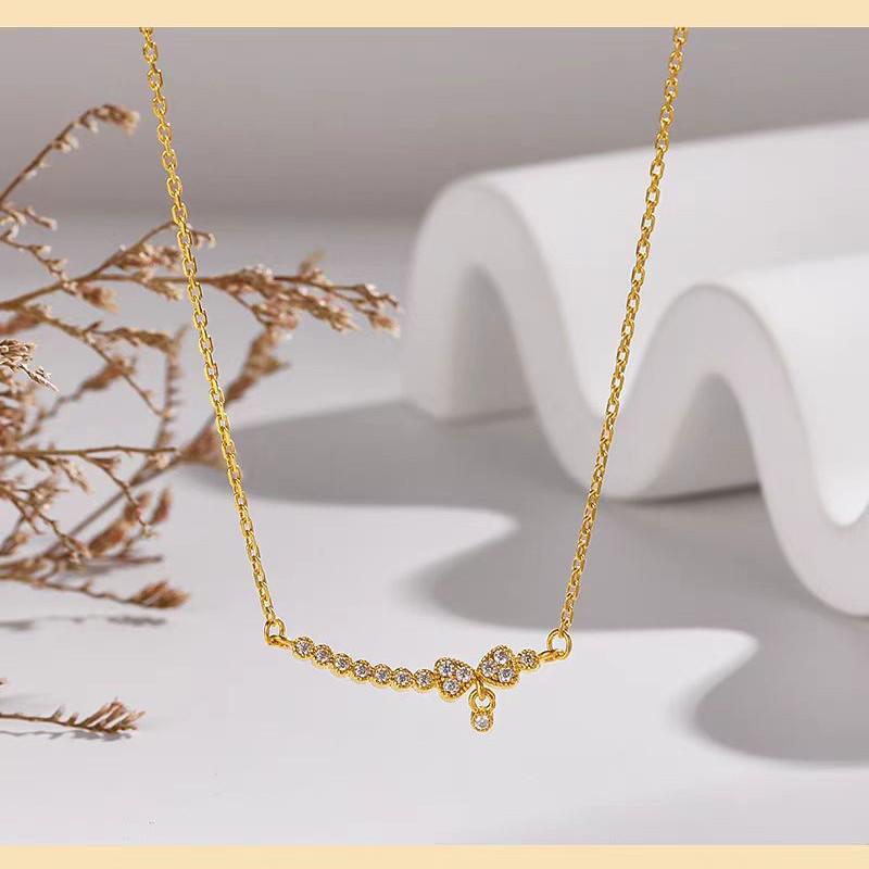 Collier Femme Doré Souriant avec Nœud, Chaîne de Clavicule Luxe Léger et Pendentif Imitation Or