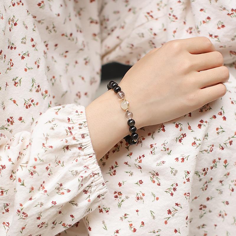 

Набор парных браслетов из натурального золотого обсидиана и лунного камня с черным рутиловым кварцем