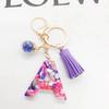 Europäischer und Amerikanischer Bestseller Englischer Initialschlüsselanhänger mit Lila Quasten-Accessoire