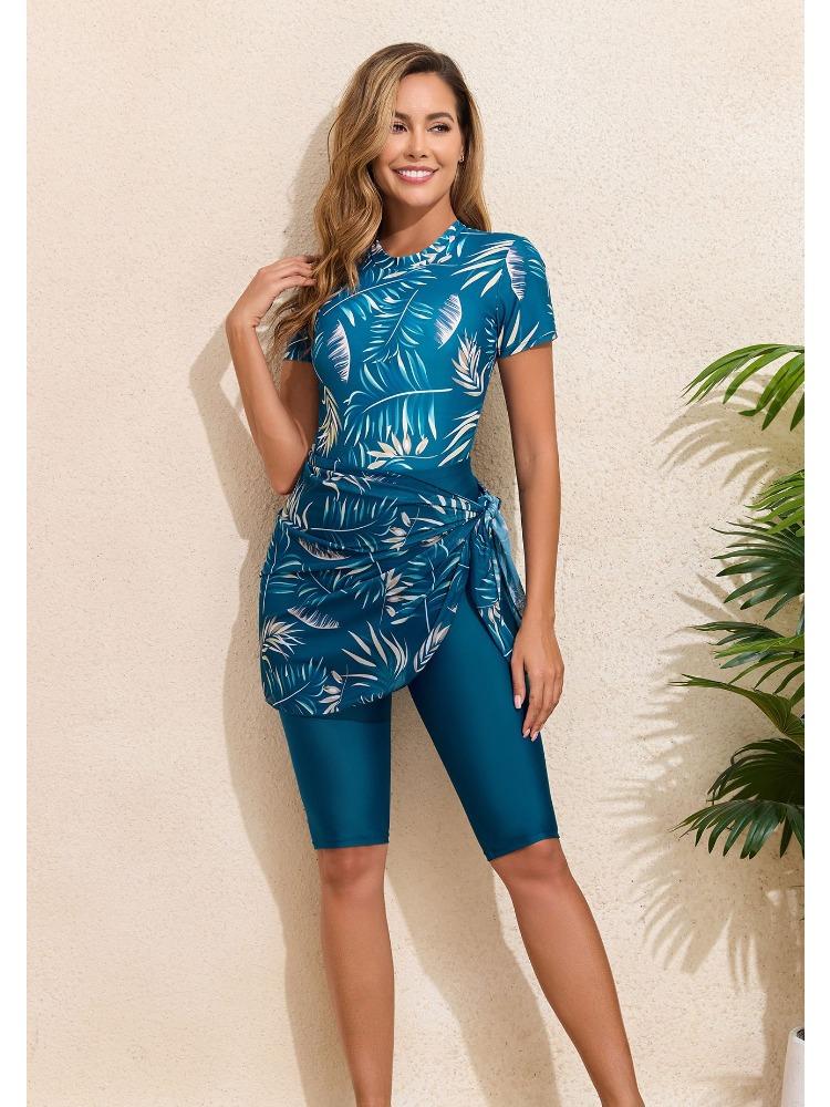Bikini a tre pezzi alla moda con stampa a foglie, cerniera, gonna annodata e pantaloncini per la spiaggia estiva