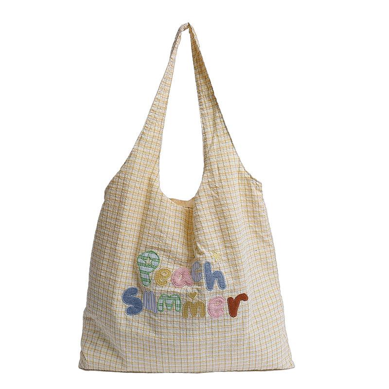 Kleine frische karierte tragbare Tragetasche Damentasche 2025 Sommer neue Mode Buchstaben-Schultertasche trendige Achseltasche