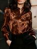An elegant women's all-purpose blouse made of silk with a floral pattern, suitable for suburban trips.