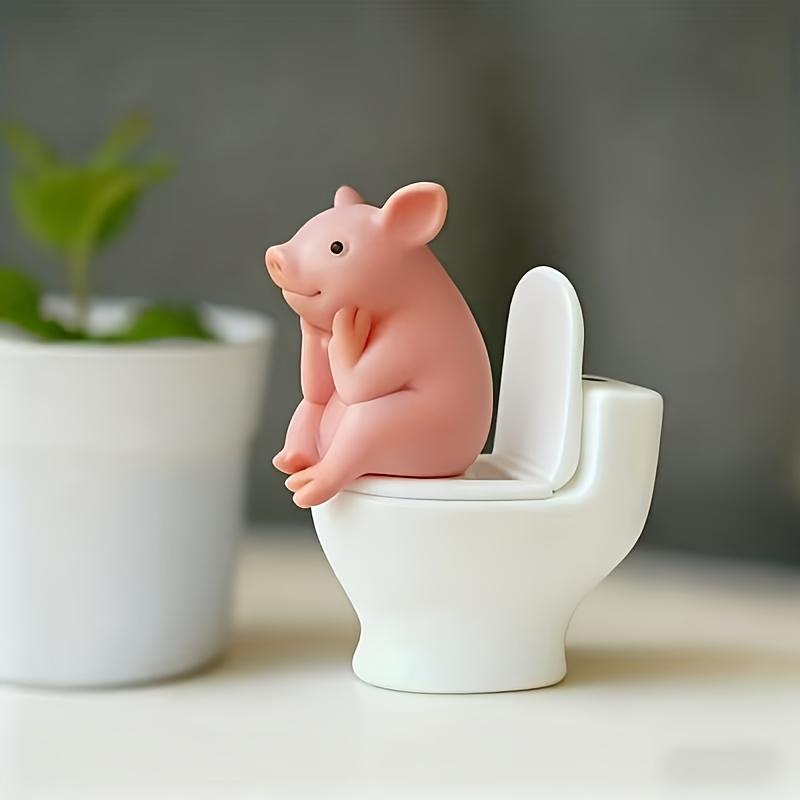 One Adorable Pig Figurine Perched on A Toilet - A PVC Decoration for Your Bathroom, Suitable for Desktop or Wall Display
