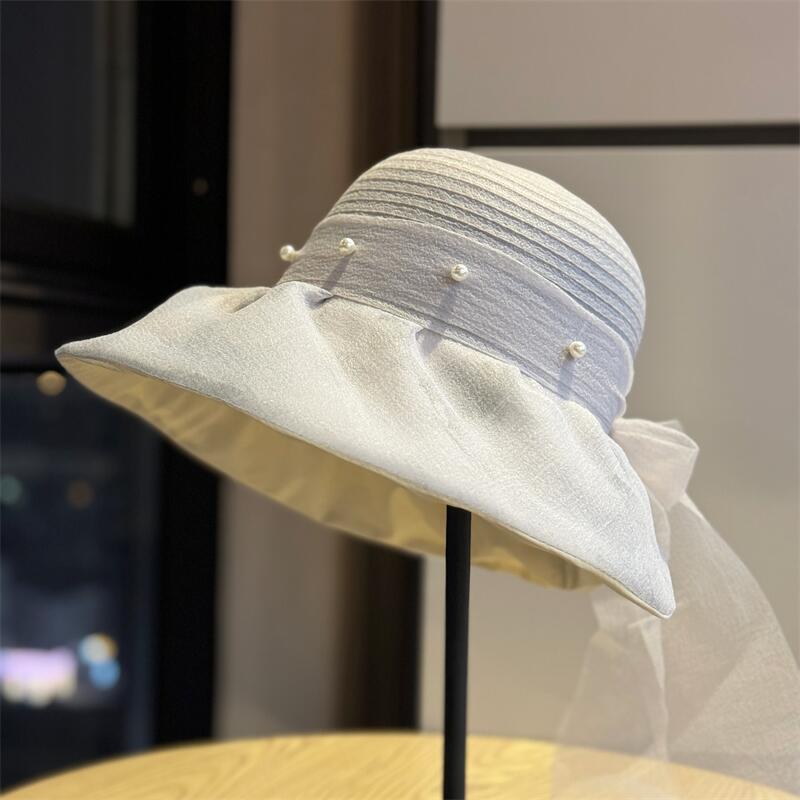 New French-style Hepburn-inspired pearl fisherman hat for women, with fairy-like charm, bow tie, and ribbon, suitable for sun protection and casual