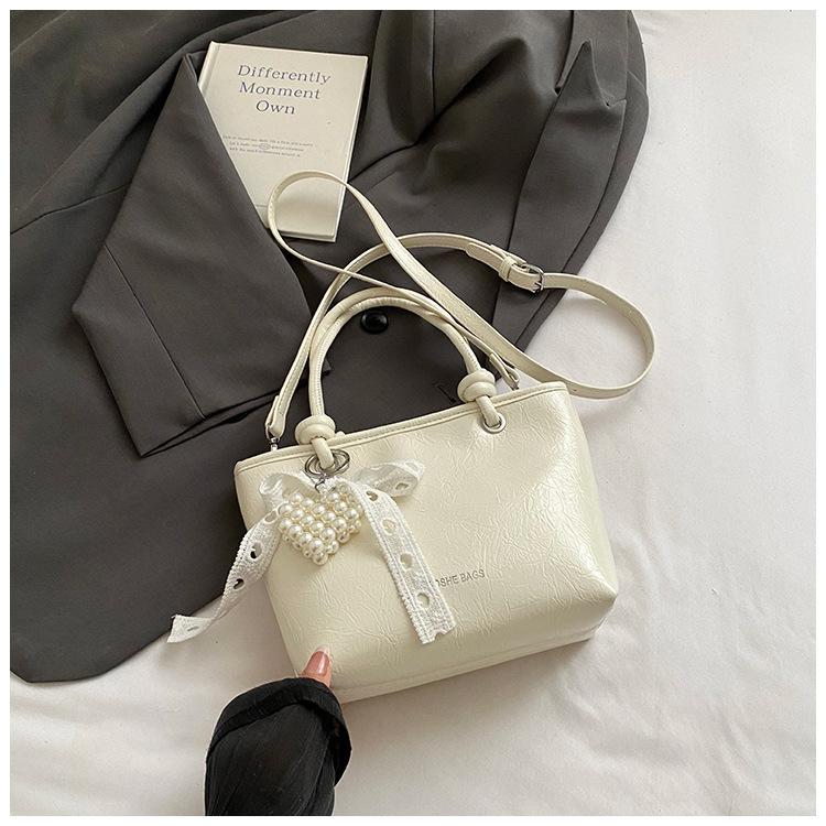 

Korean version of lace women s bag 2025 summer new commuter simple oblique span hand bag fashionable versatile exquisite bucket bag білий