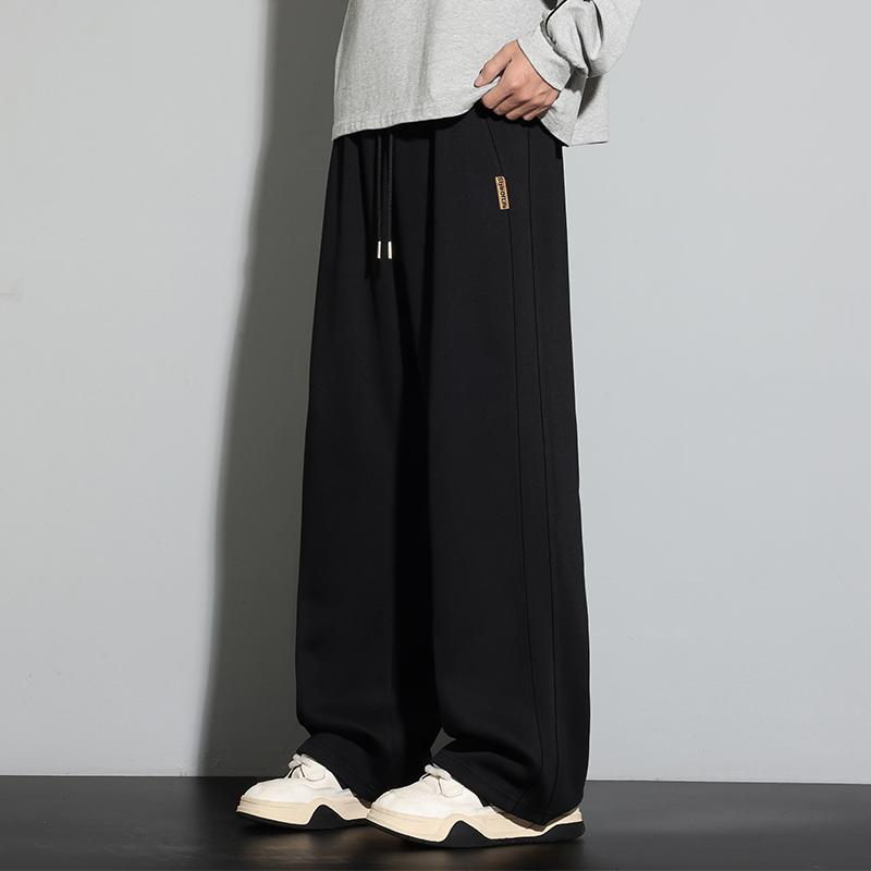 Spodnie dresowe męskie luźne casualowe na wiosnę i jesień z elastycznym pasem i szerokimi nogawkami spodnie proste