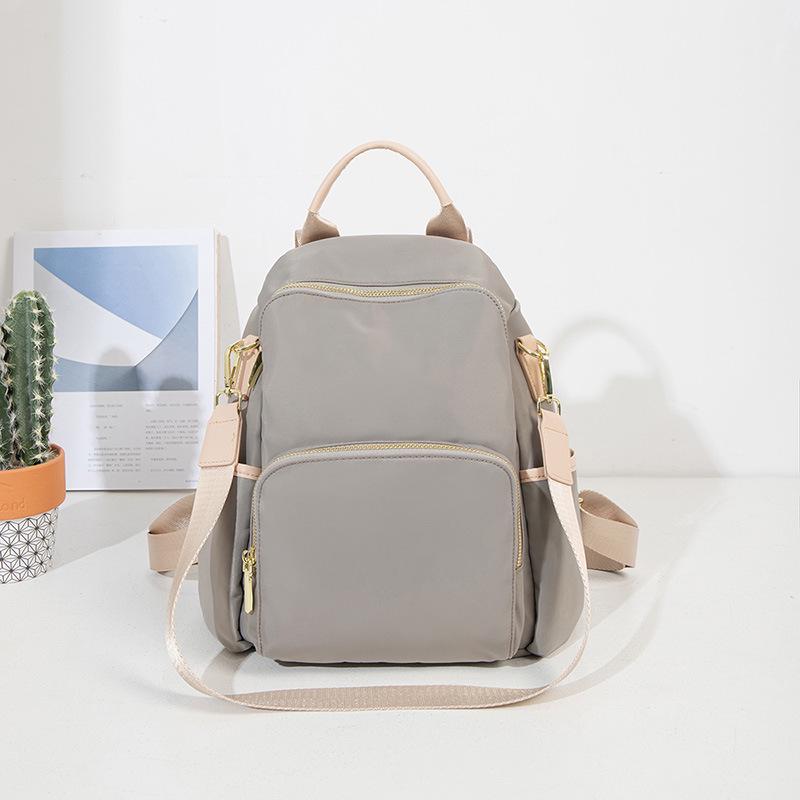 

2024 Женский легкий водонепроницаемый рюкзак из ткани Оксфорд - Большая вместимость, защита от краж, идеально подходит для путешествий и поездок на работу. 18 inch светло-серый