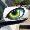 Two Imaginative Vehicle Decals Featuring Bright Three-Dimensional Green Cat-Like Eyes That Seem To Be Watching