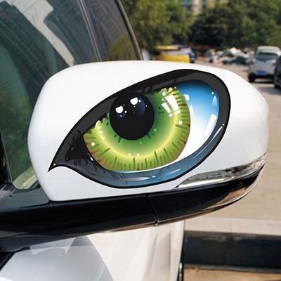 Two Imaginative Vehicle Decals Featuring Bright Three-Dimensional Green Cat-Like Eyes That Seem To Be Watching