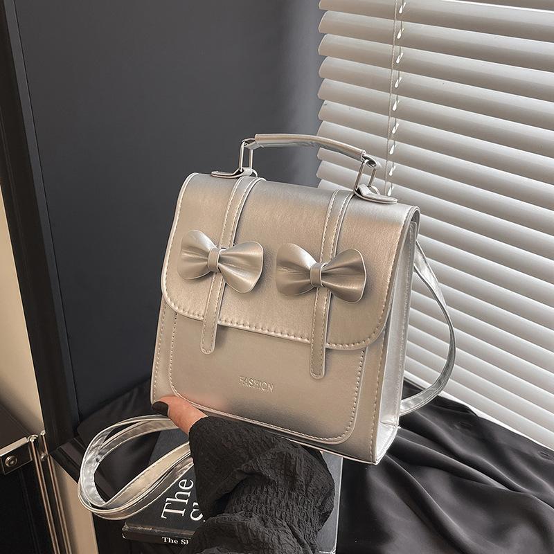 South Korea solid color college style commuter backpack women 2025 new trend bow portable shoulder messenger bag