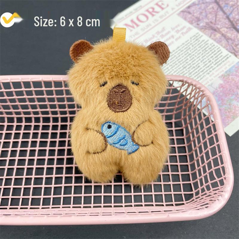 

Plush Capybara Ornament: Cute Fish-Holding Cartoon Pendant for Backpack, Socks, and Accessories. Original (with Hanging Hole)