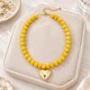 Adjustable Beaded Pendant Necklace with Rounded Resin Beads, Heart-Shaped Center Pendant, Extension Chain, and Lobster Clasp