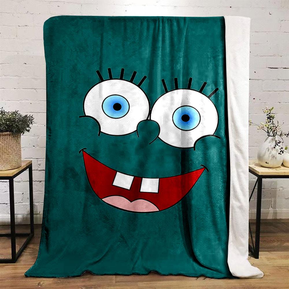 Bright cartoon face with large blue eyes, wide smile, and prominent teeth. for all seasons blanket lunch break throw gift