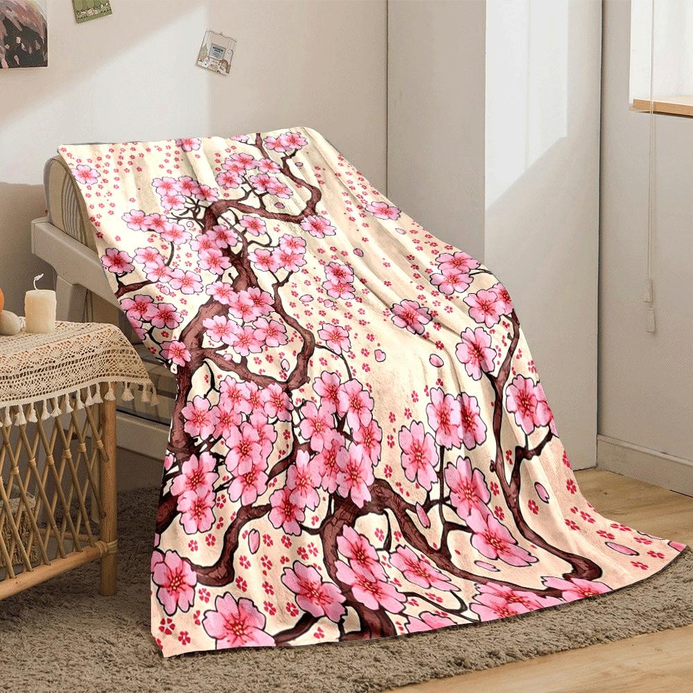 Pink cherry blossoms with brown branches and scattered petals on beige. for all seasons blanket lunch break throw gift