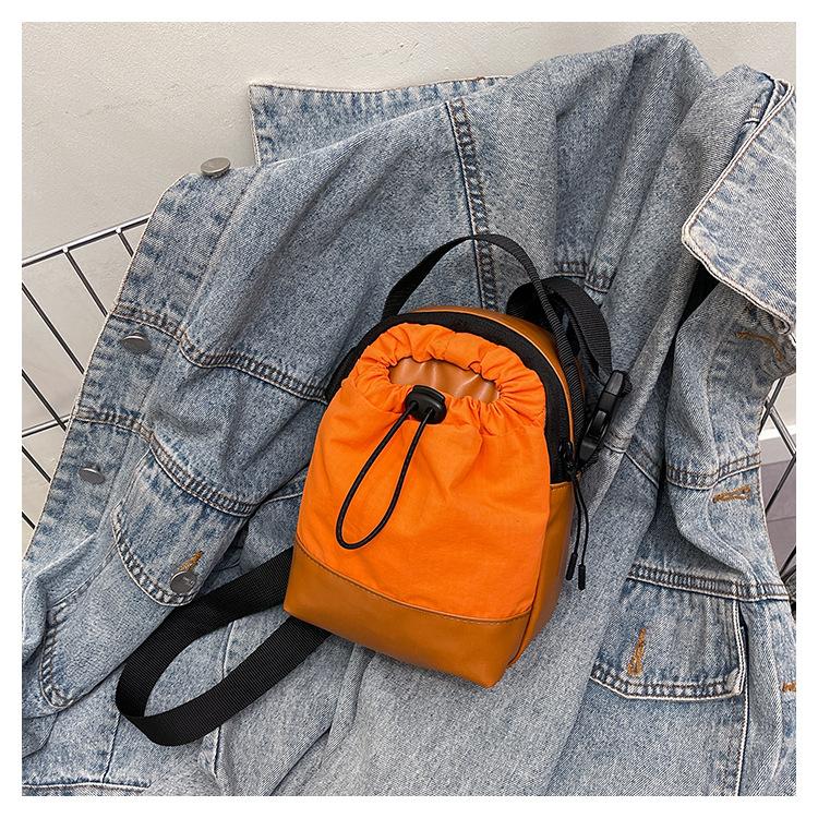 

Lightweight waterproof + canvas splicing casual personalized summer tide with drawstring vertical messenger mobile phone small square bag оранжевый