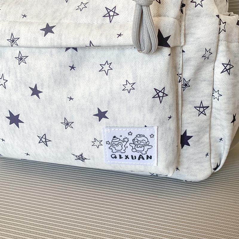Star-Printed Backpack with Front Zipper Pocket and Tassel Details for School and Daily Use