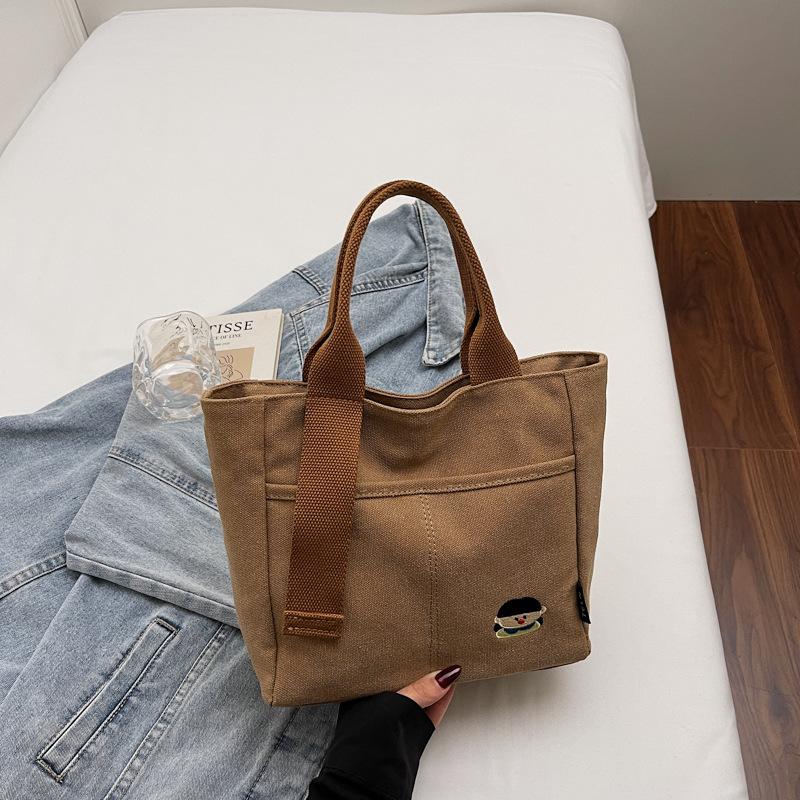 Lightweight canvas bag women's 2025 new autumn and winter leisure college students class portable commuter bag portable bucket bag