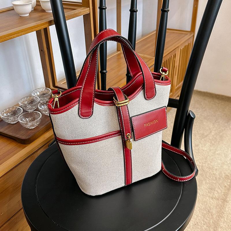 Canvas niche contrasting color handbag women's 2025 summer new Korean fashion shoulder messenger bag versatile bucket bag