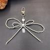 Fashionable Korean-inspired Blogger-style Large Pearl Bow Mobile Phone Pendant Key Chain with Heart Design.