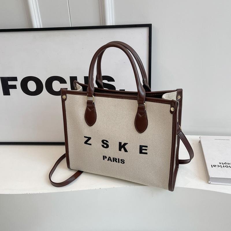 

New fashion niche simple canvas portable shoulder oblique span women s bag темно-коричневого